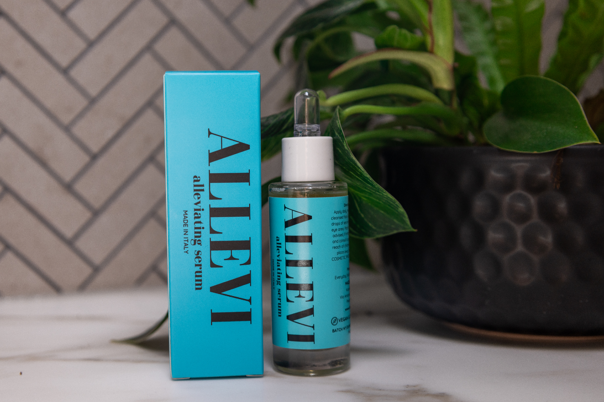 The Alleviating Serum bottle and box in soft daylight